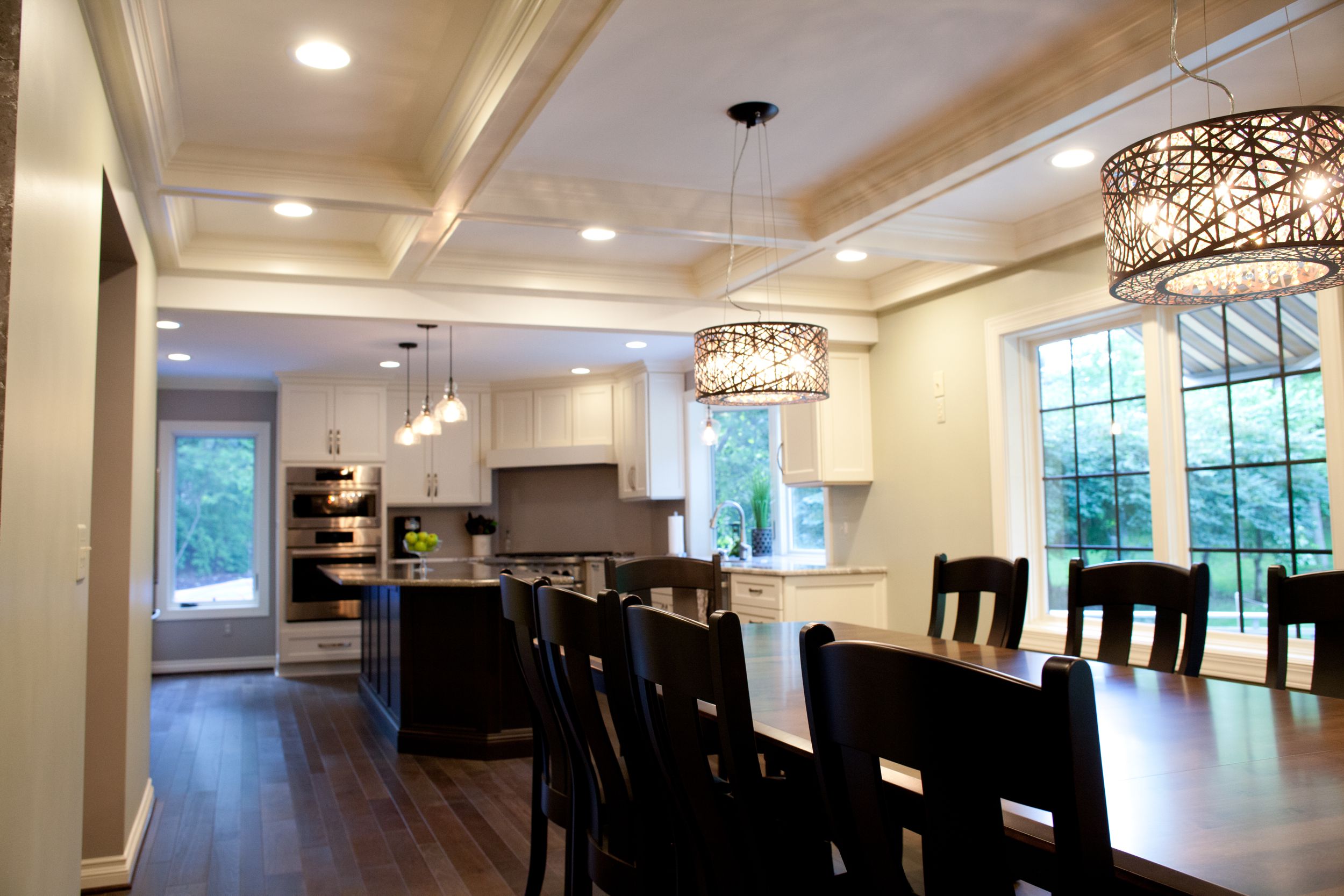 Wood table with white coffered ceilings above