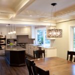 White kitchen cabinets with wood island