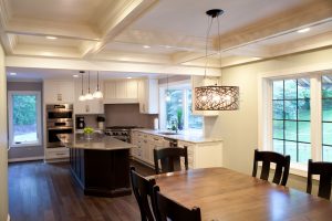 White kitchen cabinets with wood island