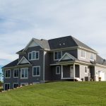 Two story home with grey siding and white trim