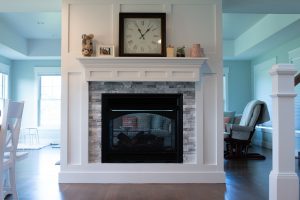 See thru fireplace with wood trim surround