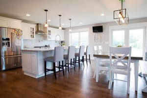 Open kitchen and eating area with white cabinets and trim