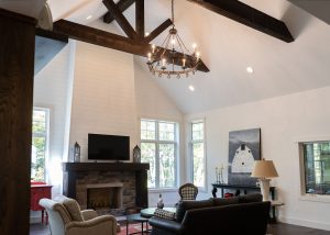 Living room with fireplace and timber trusses