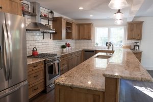 Rustic wood cabinets in a kitchen with subway tile walls
