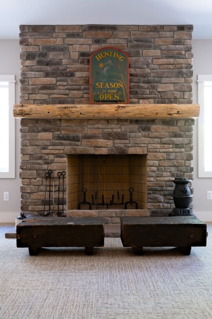 Stone fireplace with wood mantle