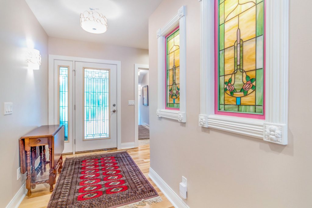 Light and airy entry hall with stained glass inserts on right wall