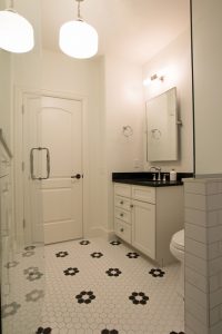 White tile with black accents in a retro bathroom
