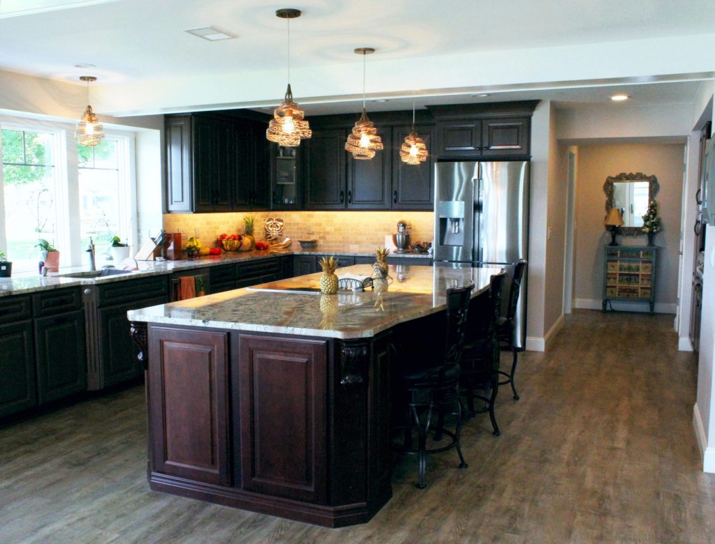 Dark wood cabinets wrap the kitchen with a large center island