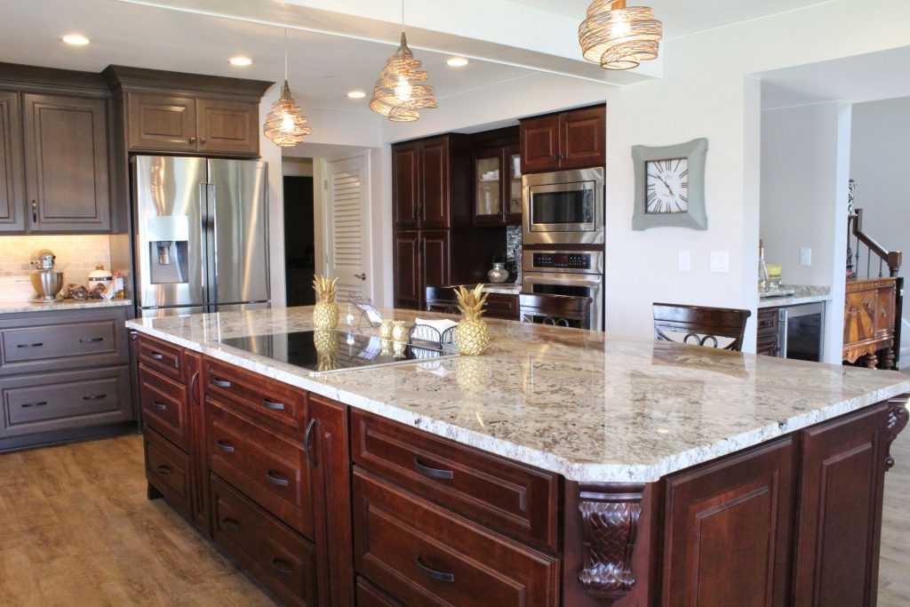 Large granite island with wood cabinets