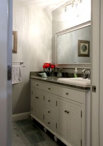 White vanity cabinets with granite counter