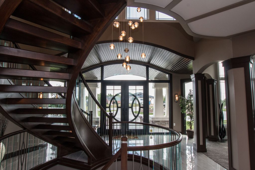 Looking through the entry towards the front door with winding staircase