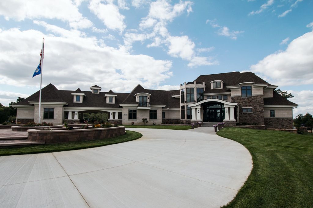 Front view of custom home with circle drive