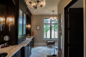 Dark wood cabinet flank the left side of this rich master bathroom