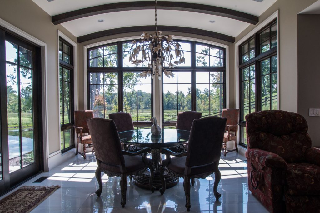 Luxurious table in glass sunroom with arched ceiling