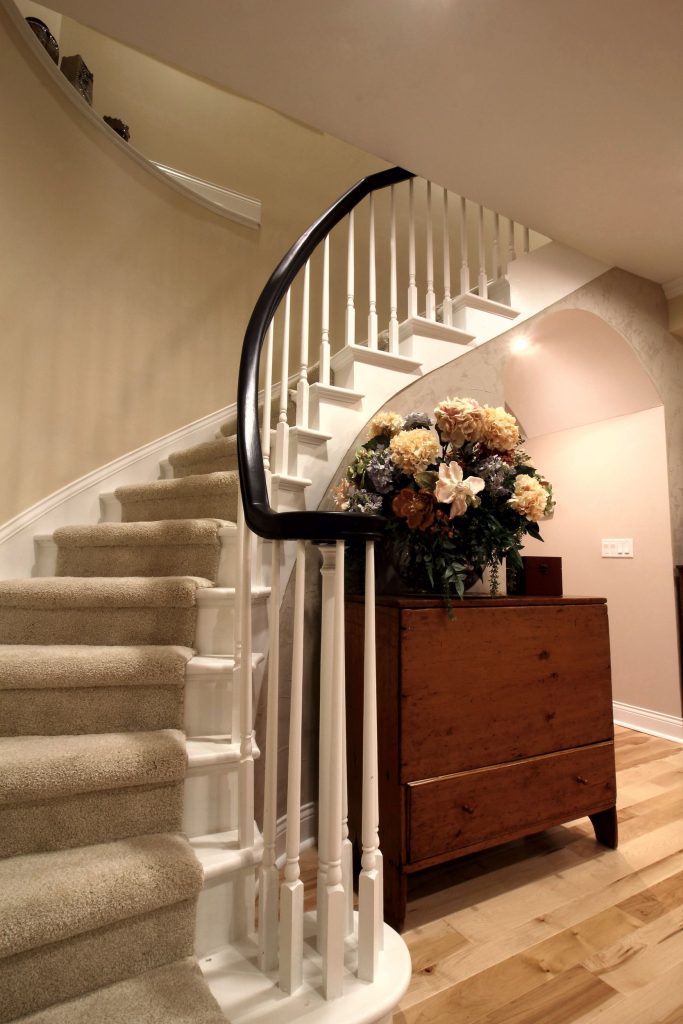 Curved staircase with painted white treads and balusters